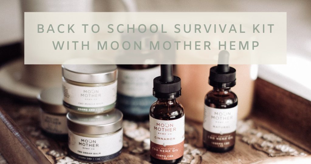 CBD balms and hemp oil tinctures on a wooden tray, with the words Back to School Survival Kit with Moon Mother Hemp
