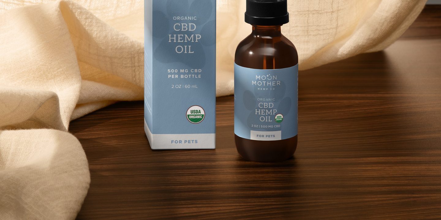 CBD Hemp Oil for pets and its box on a wooden table